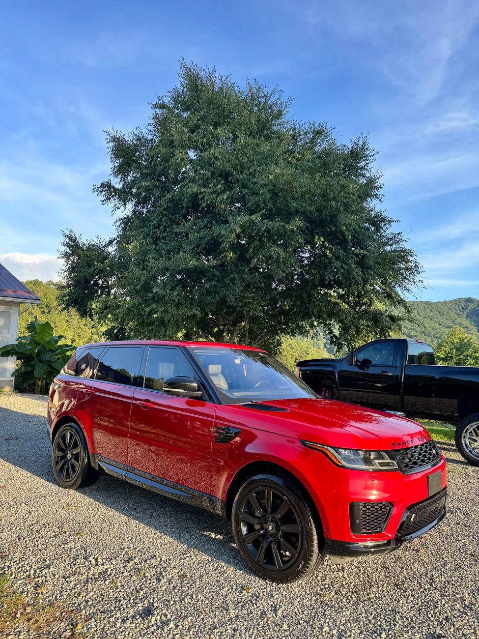 A freshly detailed red Range Rover outside on a clear day